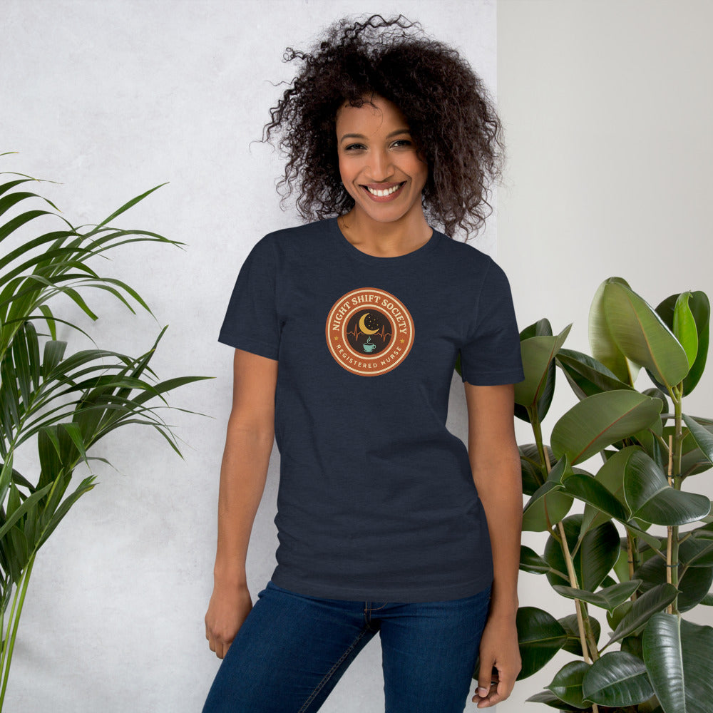 Night Shift Society retro registered nurse badge tee — Heather Navy, on model