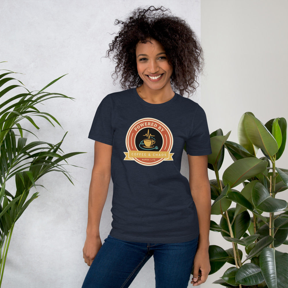 Powered by Coffee & Chaos retro nurse badge tee — Heather Navy, on model
