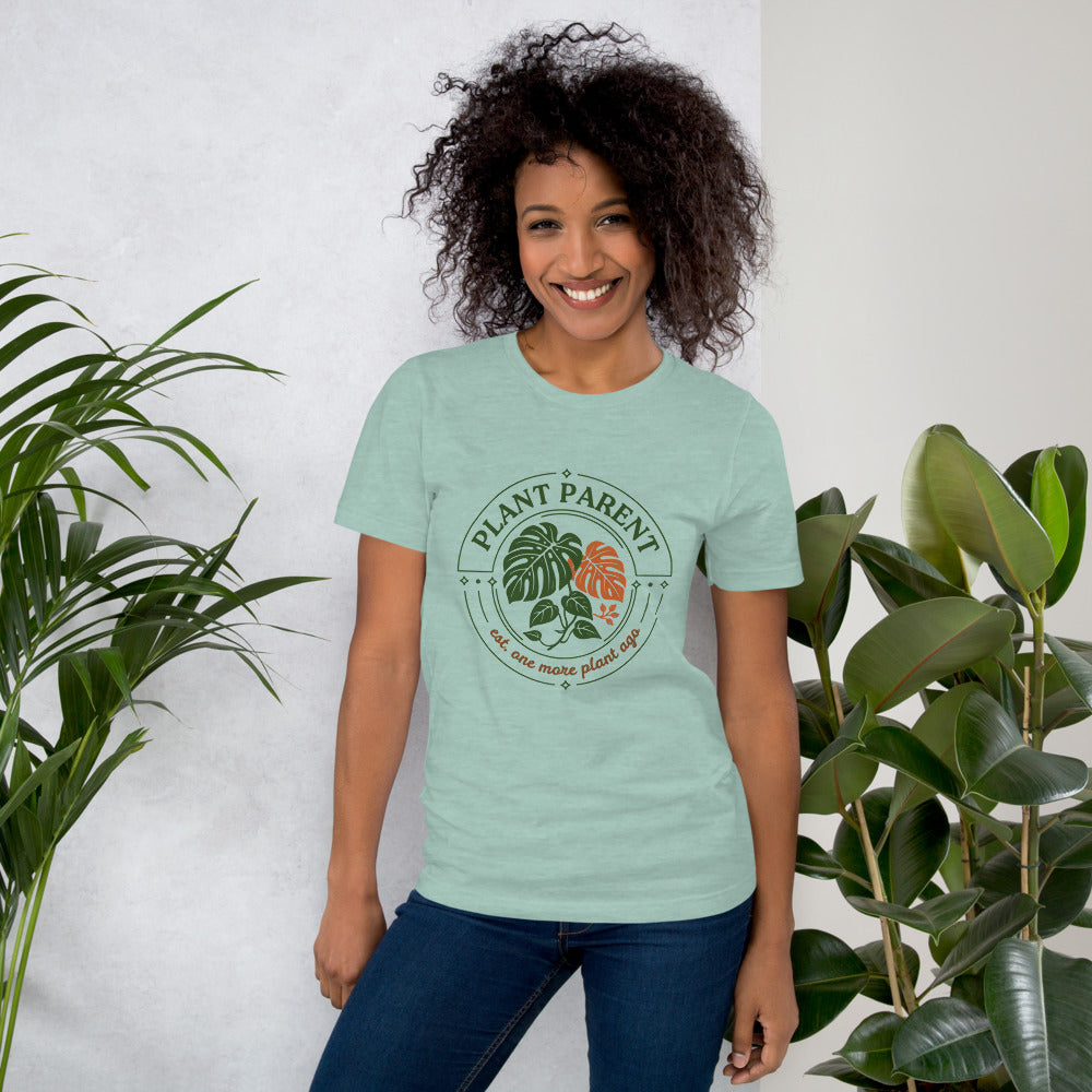 Model wearing the Plant Parent retro botanical badge tee — Heather Prism Dusty Blue