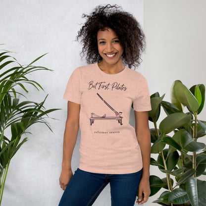 But First Pilates reformer line-art tee — Heather Prism Peach, on model