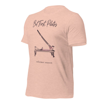 But First Pilates reformer line-art tee — Heather Prism Peach, front-right