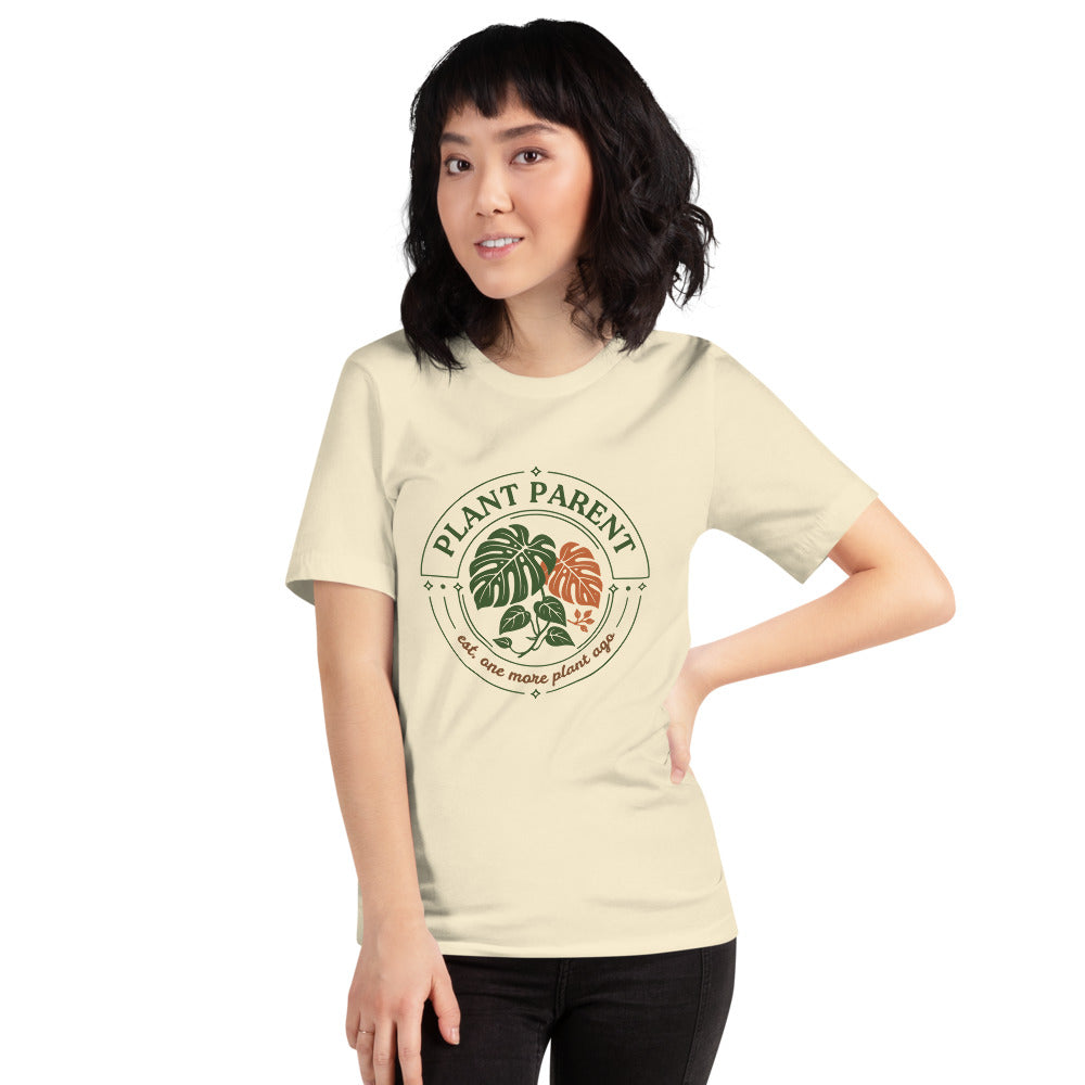 Model wearing the Plant Parent retro botanical badge tee — Natural