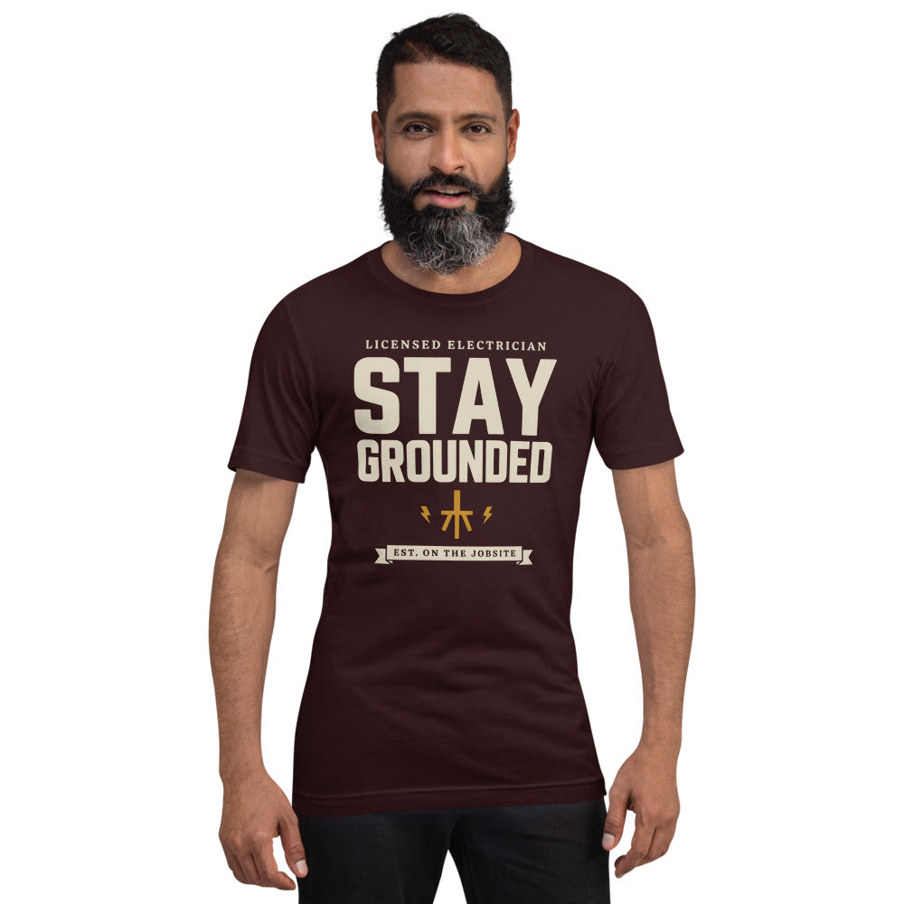 Stay Grounded funny electrician tee — Oxblood Black, on model