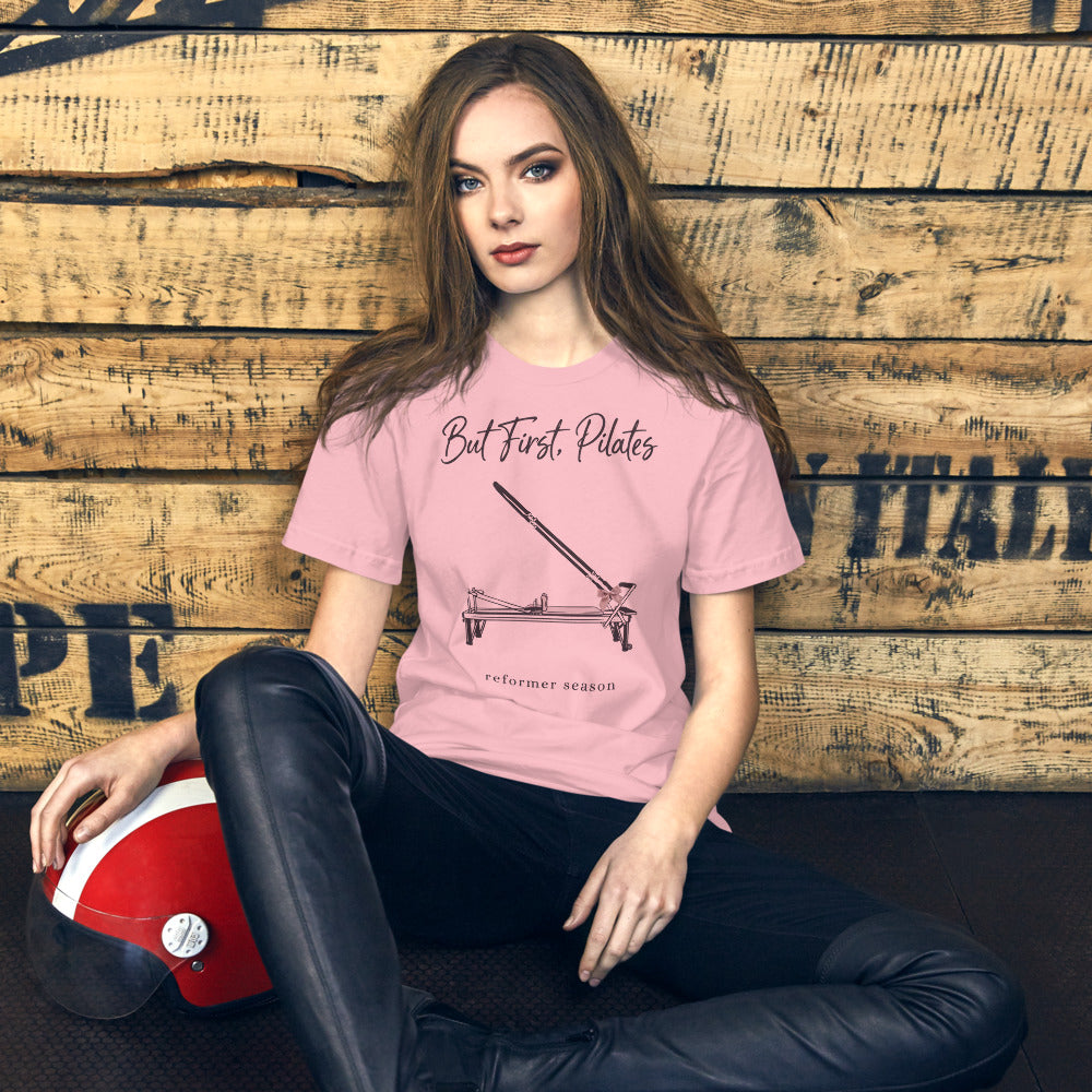 But First Pilates reformer line-art tee — Pink, on model