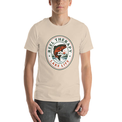 Reel Therapy retro national-park trout badge fishing tee — Soft Cream, on model