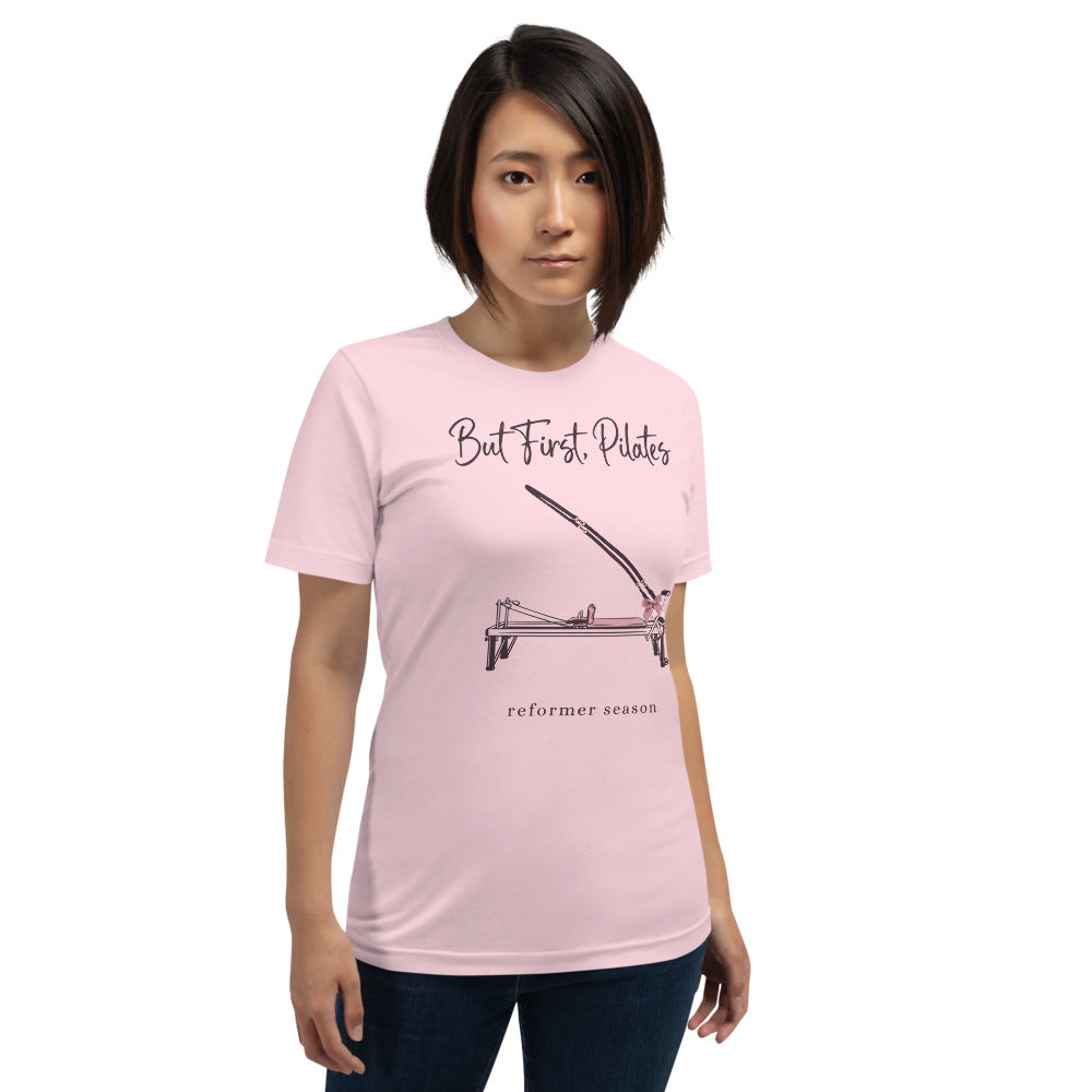 But First Pilates reformer line-art tee — Soft Pink, on model