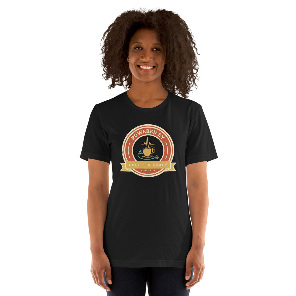 Powered by Coffee & Chaos retro nurse badge tee — Vintage Black, on model