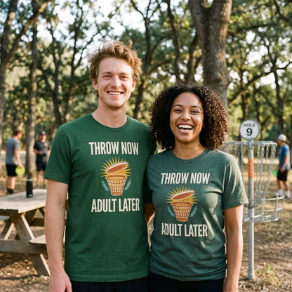 Throw Now Adult Later disc golf retro tee — two friends at the disc golf course, Forest and Heather Forest