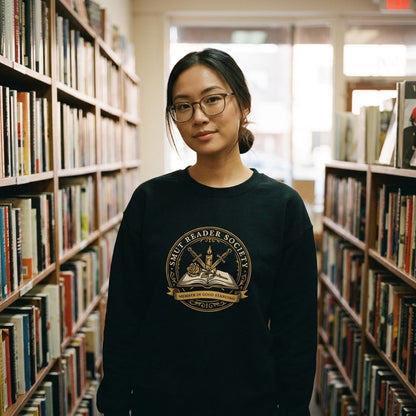 Smut Reader Society crewneck sweatshirt — East-Asian woman browsing an independent bookstore, Black