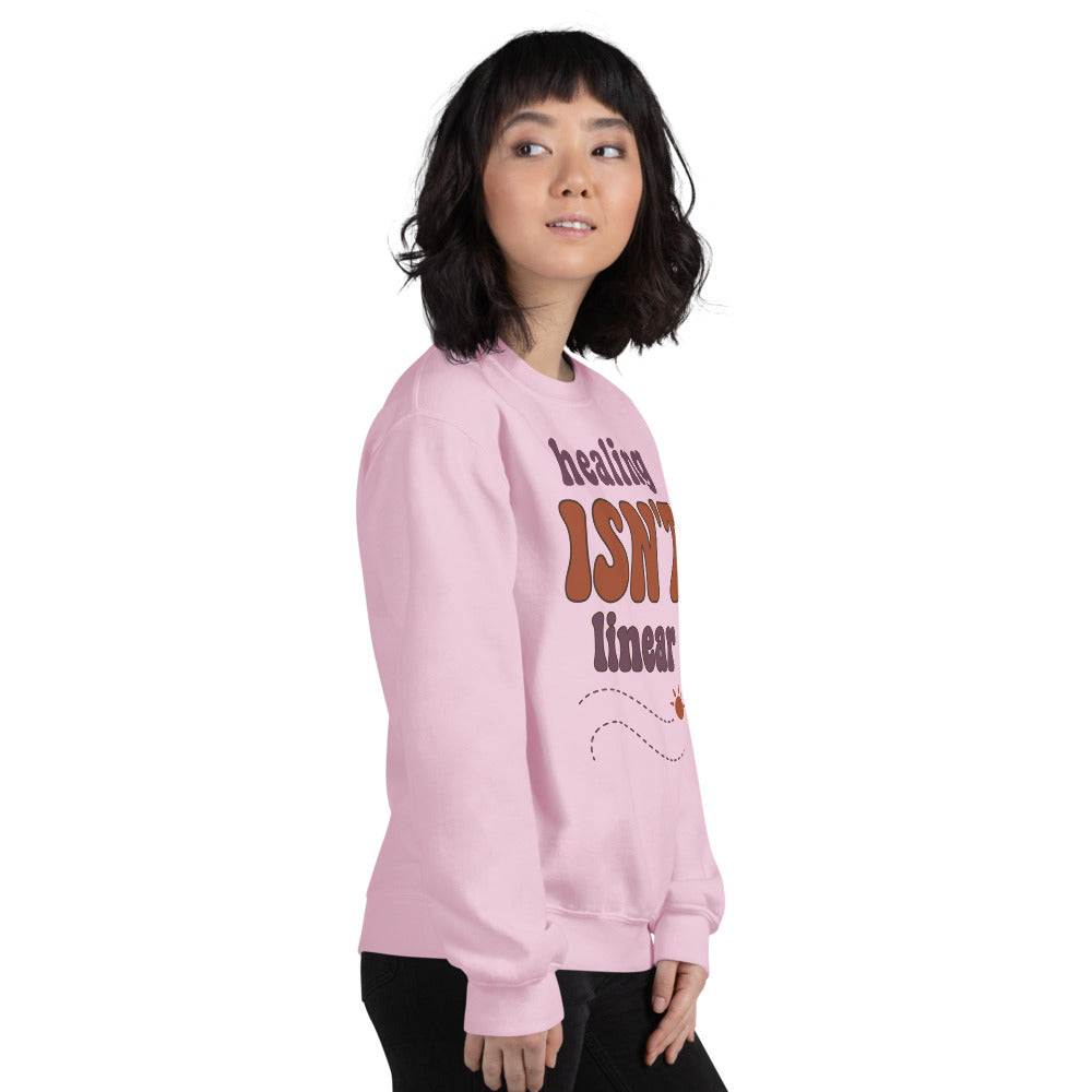 Healing Isn't Linear soft retro mental health crewneck sweatshirt — Light Pink, worn by model