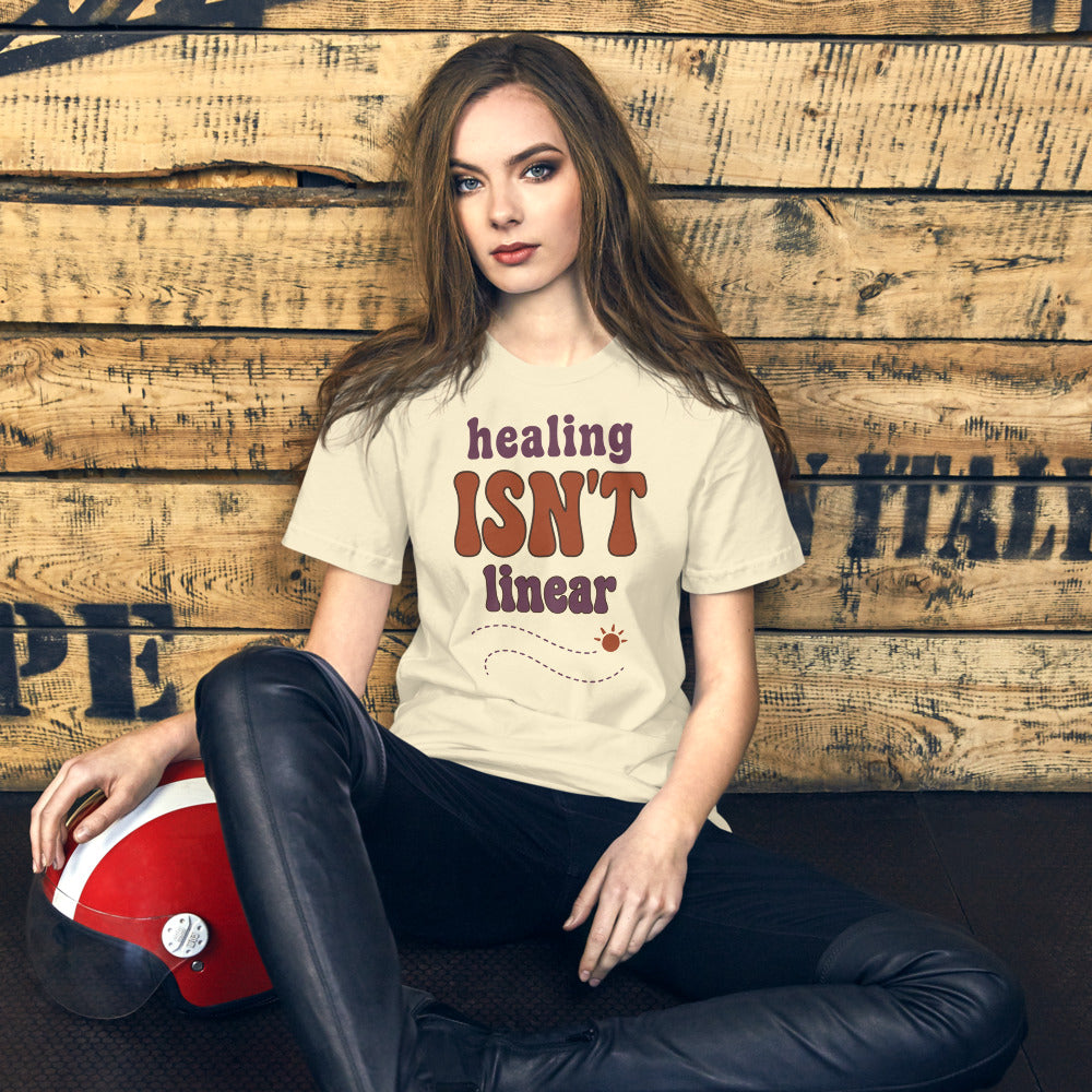 Healing Isn't Linear soft retro mental health tee — Natural, on model