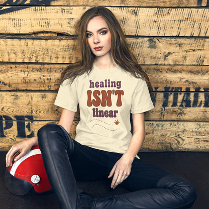 Healing Isn't Linear soft retro mental health tee — Natural, on model