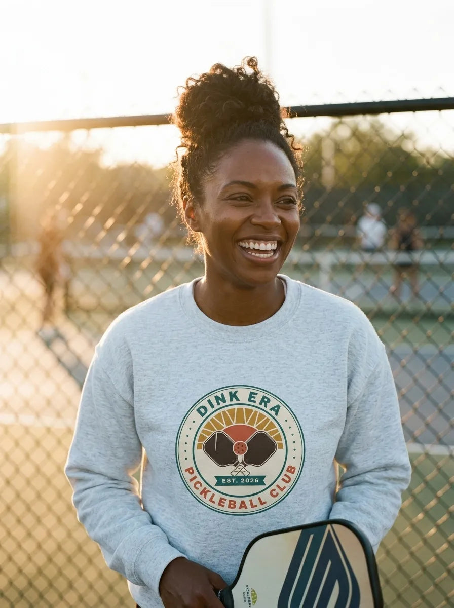 Dink Era Pickleball Club crewneck on a player in Ash — courtside golden-hour